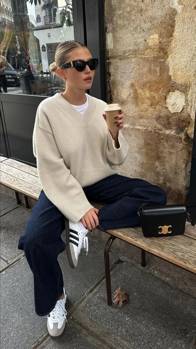 Cream V-Neck Sweater, Navy Trousers & Sneakers