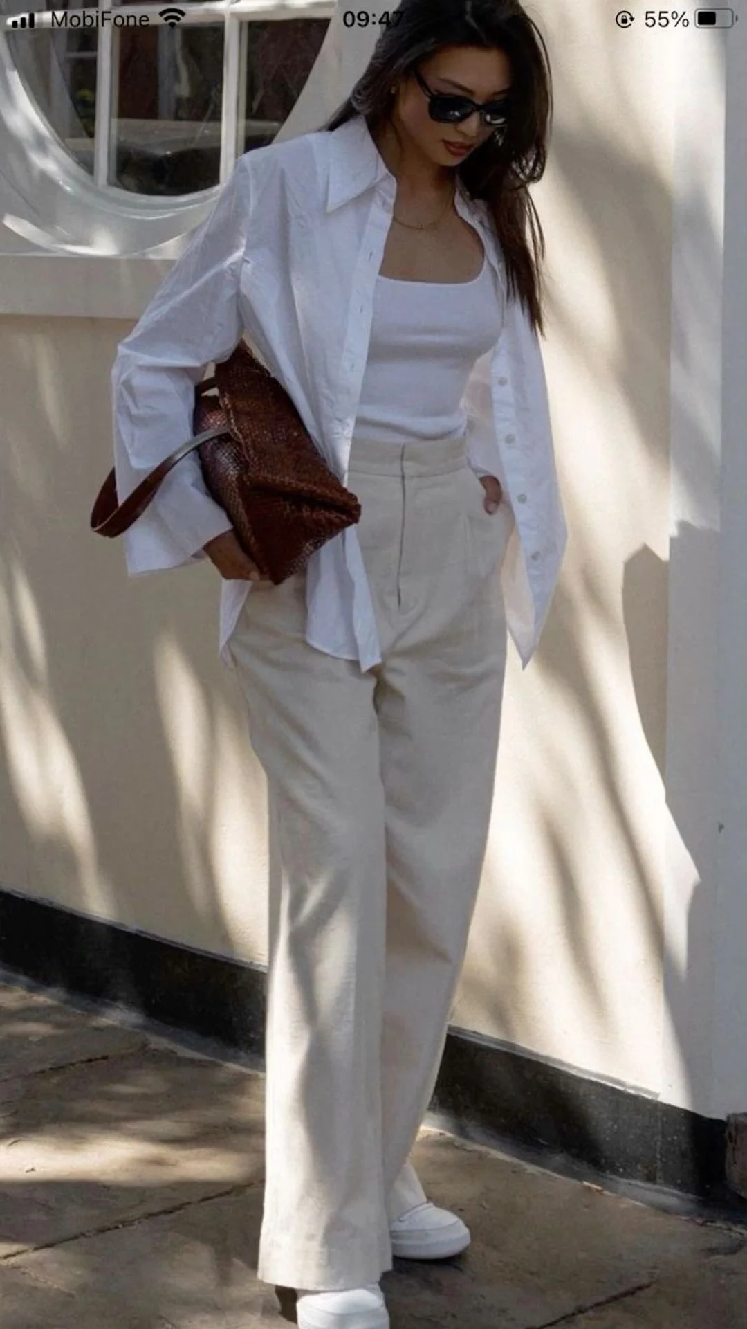 Quiet luxury neutral outfit with white shirt beige camisole and beige wide leg pants
