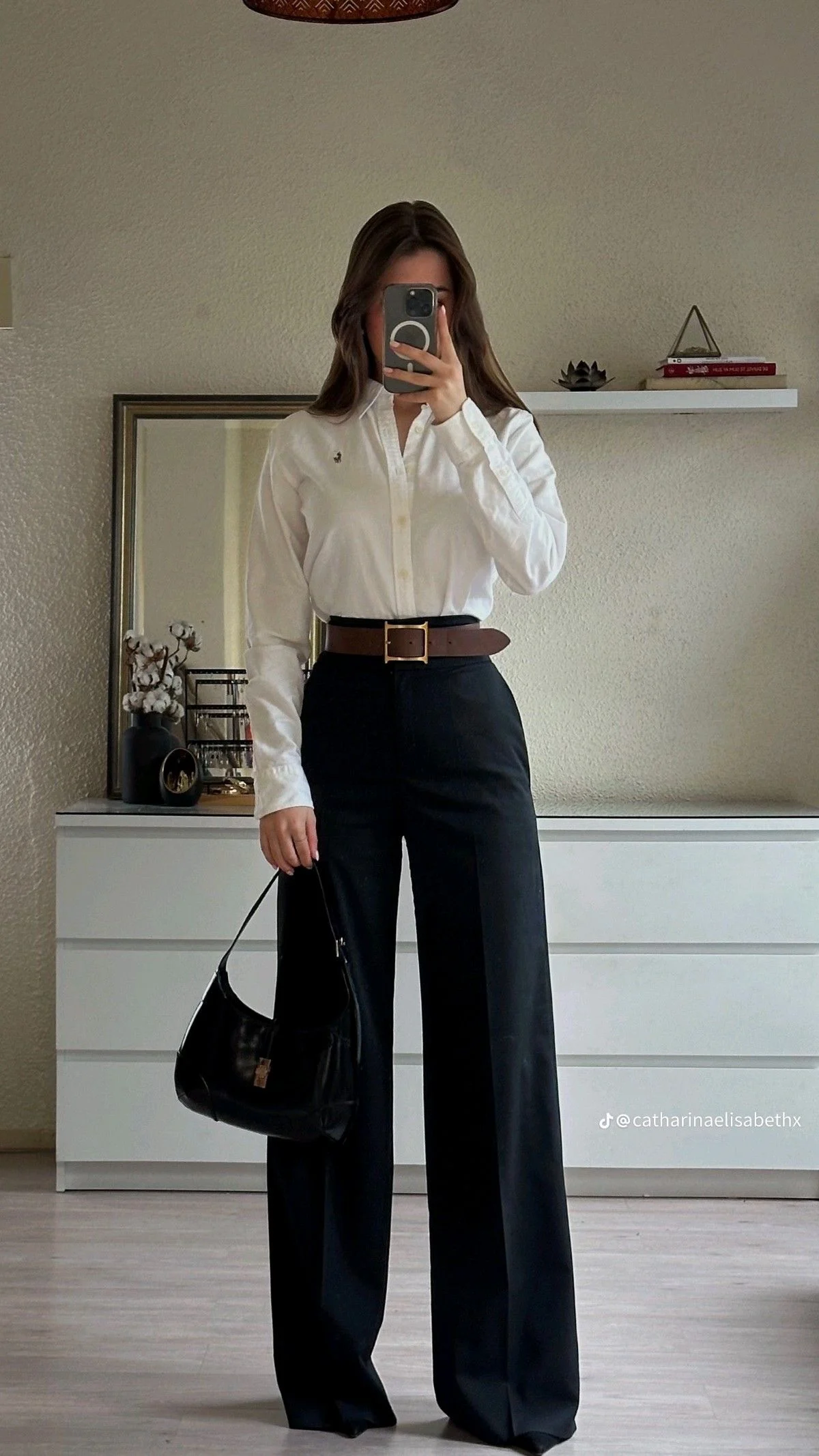 Minimalist work outfit with white oversized shirt black wide leg pants and brown wide belt